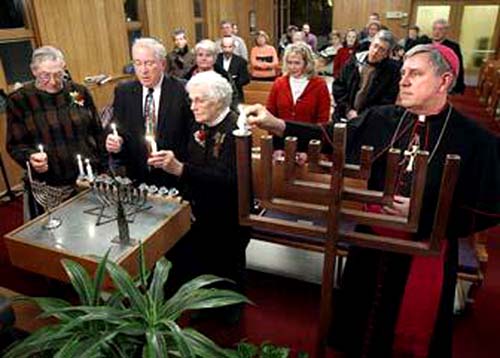 Bishop Jerome Listecki lighting a menorah